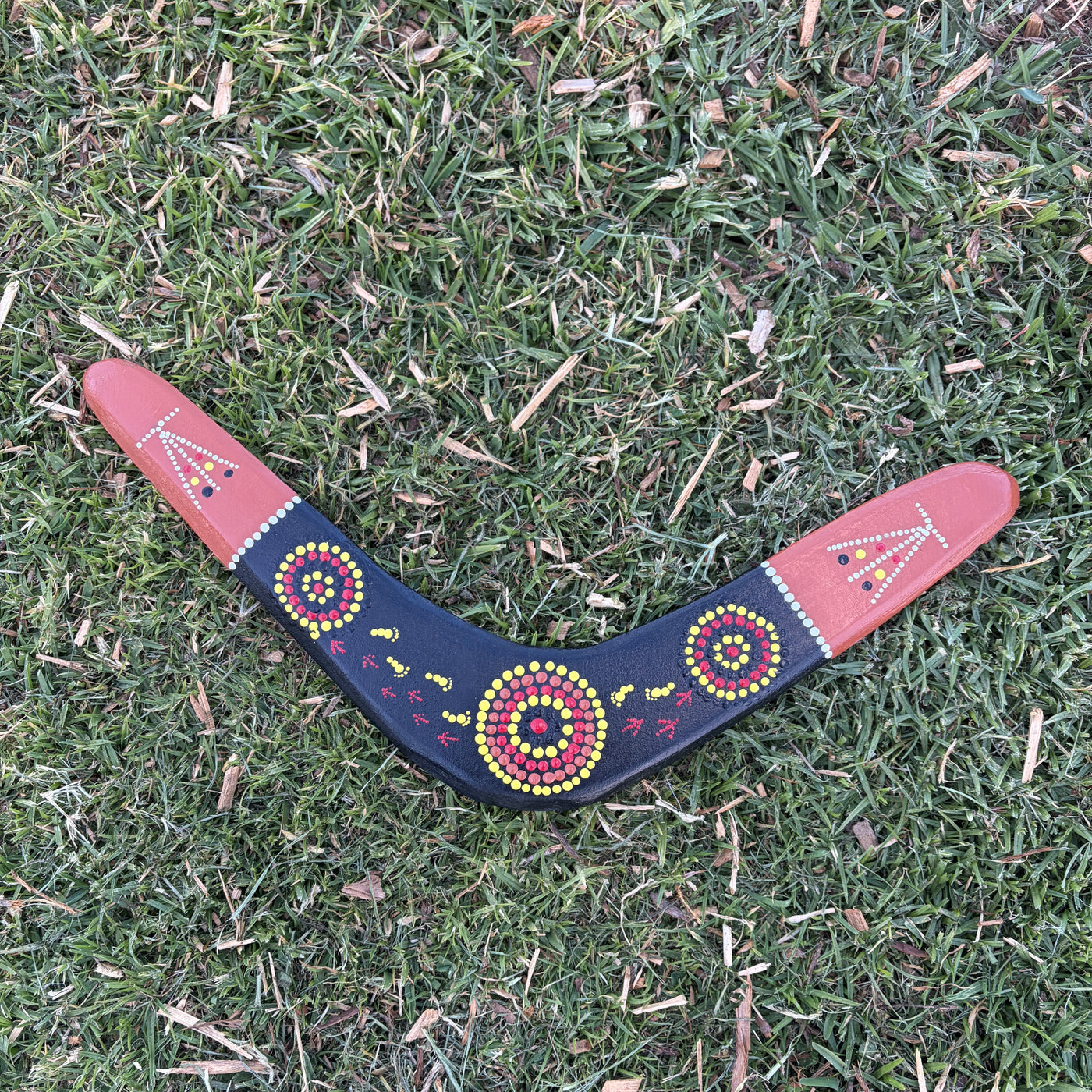 Hand Painted Boomerang with Footprints, emu prints and waterholes