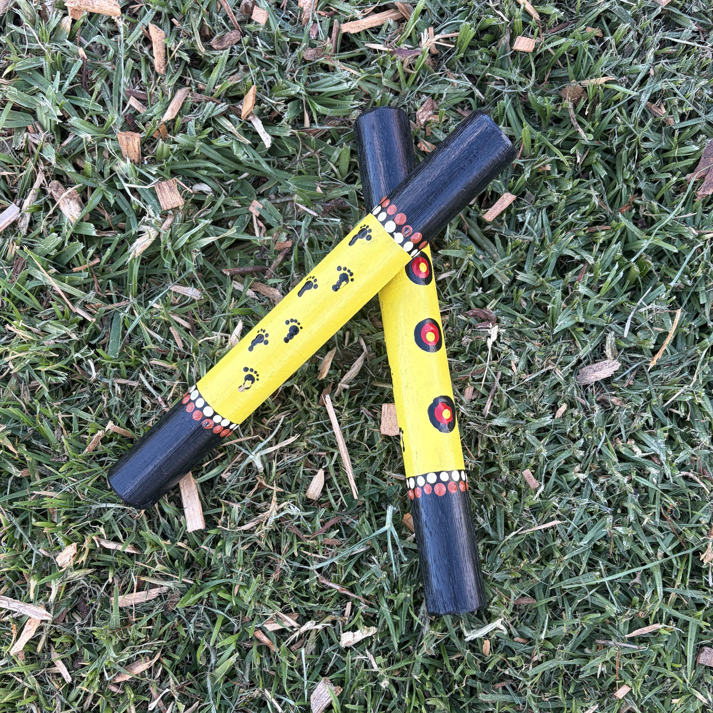 Hand Painted Clap Sticks Yellowwith Footprints and waterholes